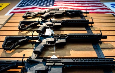 Several AR-15 Varient Rifles on the Wall
