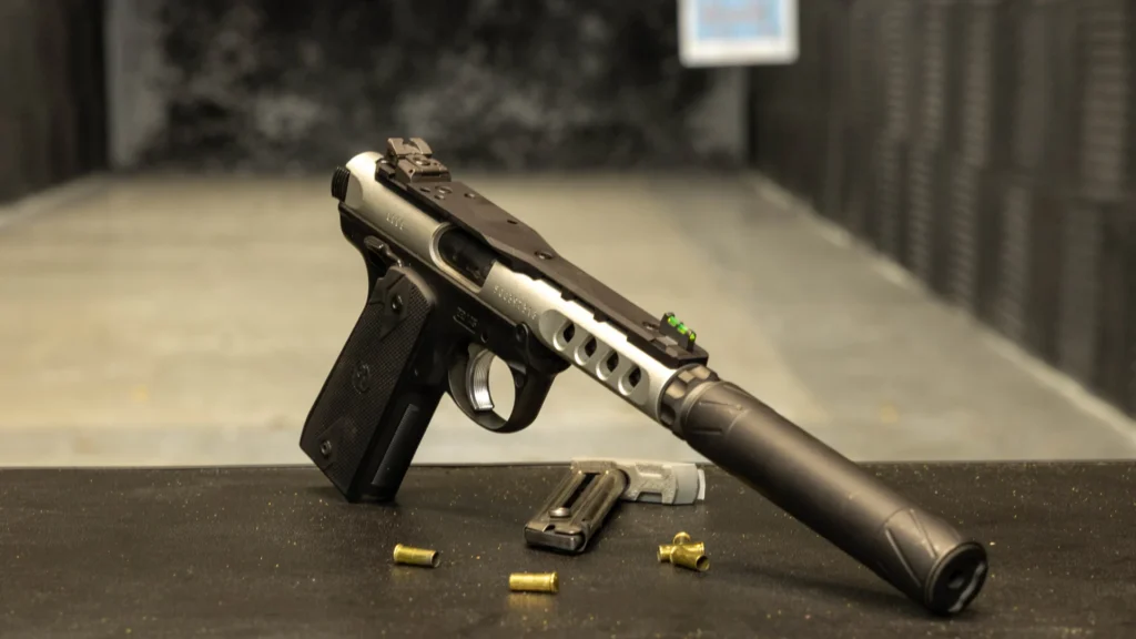 Suppressed handgun on an indoor shooting range bench